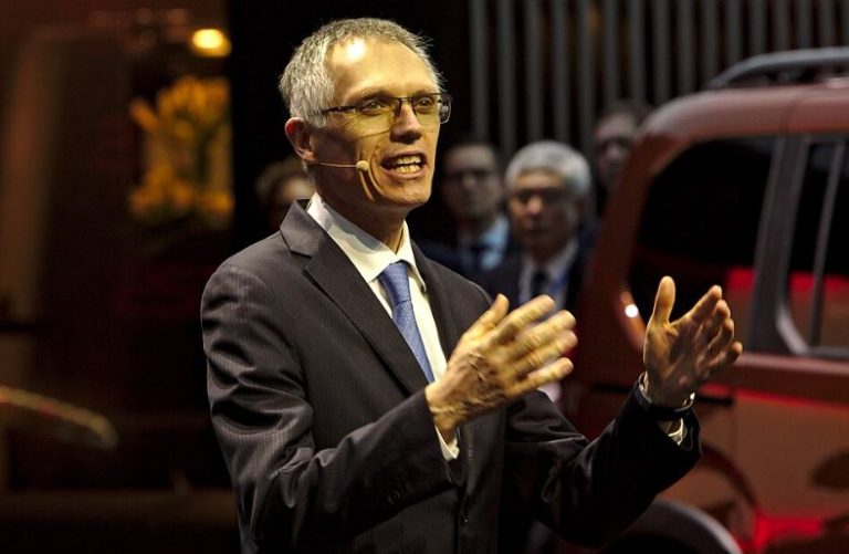 Carlos Tavares s’exprimant lors d’une présentation publique de Stellantis, micro casque et gestuelle expressive