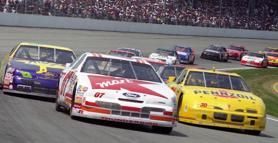 Voitures NASCAR en peloton dans Jour de tonnerre sur circuit ovale américain