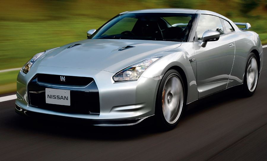 Nissan GT-R R35 grise en accélération sur route, vue trois quarts avant