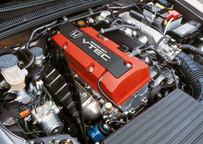 Moteur quatre cylindres atmosphérique Honda F20C VTEC de la S2000, avec cache-culbuteurs rouge.