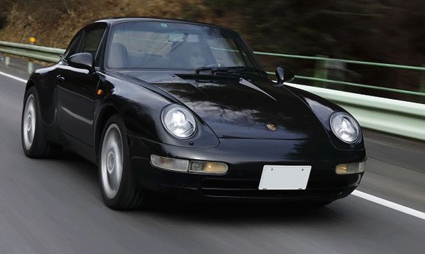 Porsche 911 type 993 noire en roulage sur route