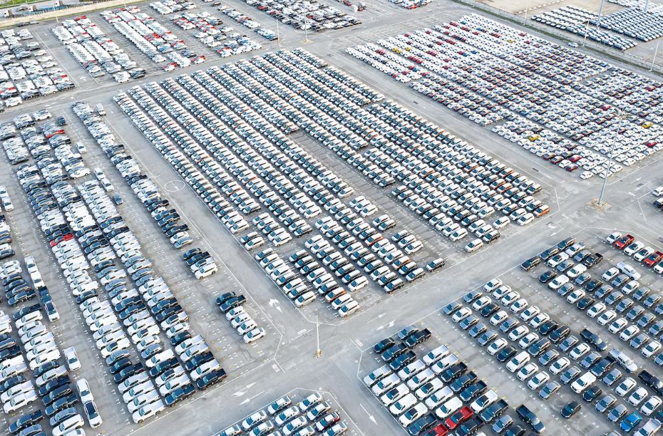 Vue aérienne de milliers de voitures stockées dans un port automobile européen