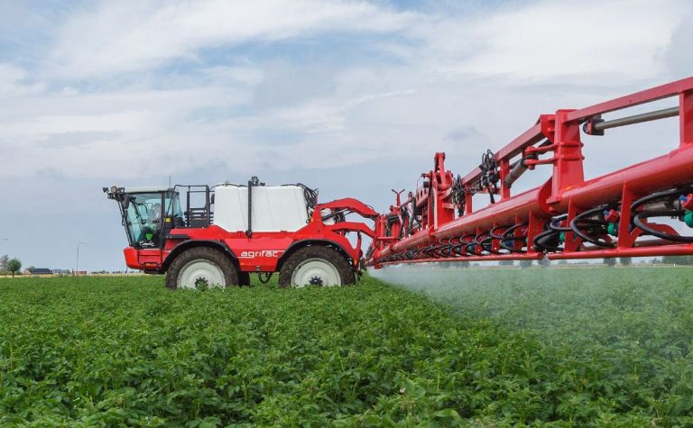 Pulvérisateur agricole traitant une culture, illustration du débat sur les néonicotinoïdes et les réglementations agricoles en Europe.