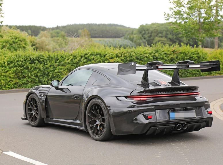 Porsche 911 GT3 RS 992 grise vue de trois quarts arrière, avec son immense aileron actif et son diffuseur.